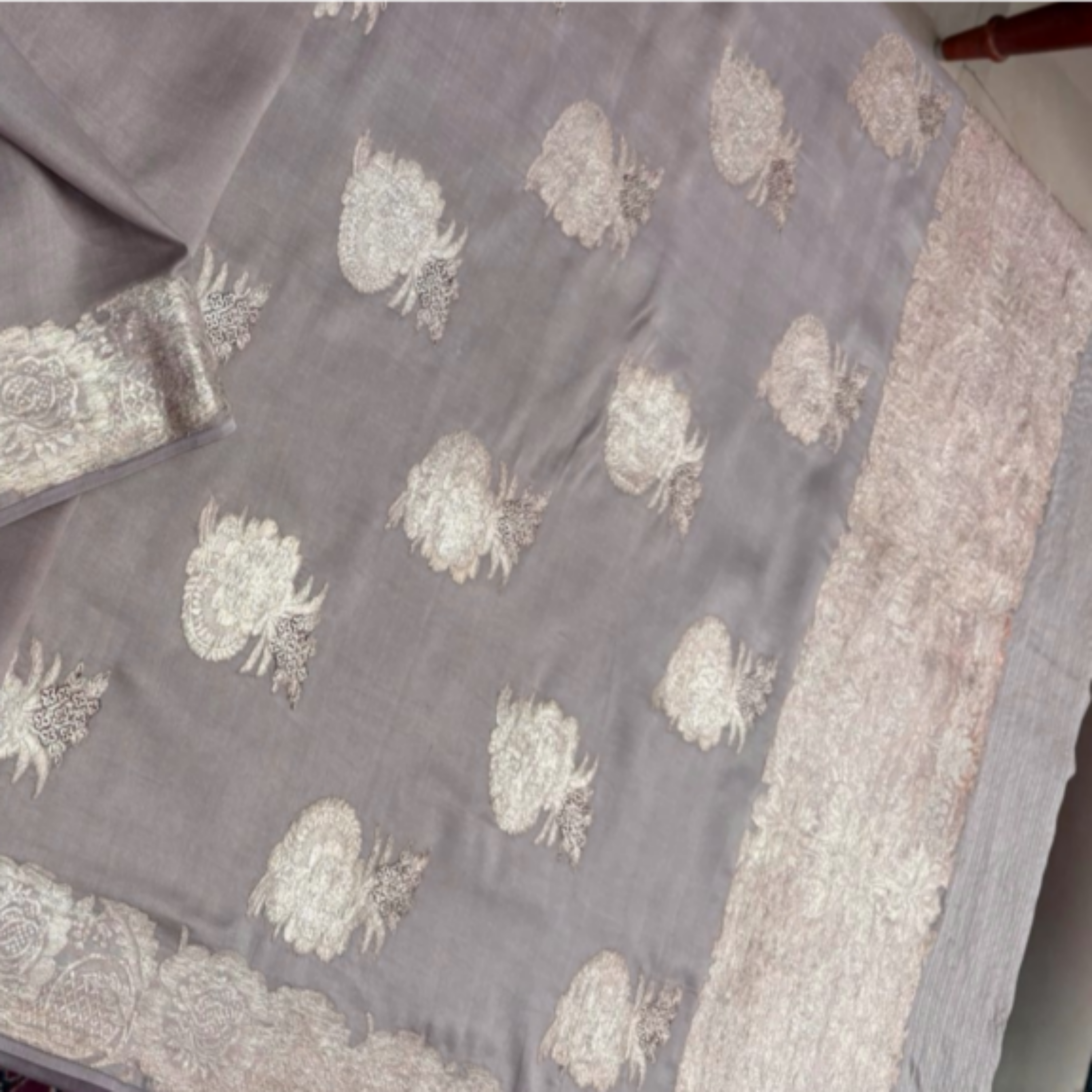 Gray fabric with floral patterns on a textured surface