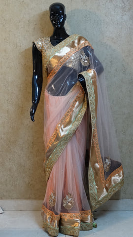 Pastel on Pastel Peach Net Saree with heavy Border and Motifs